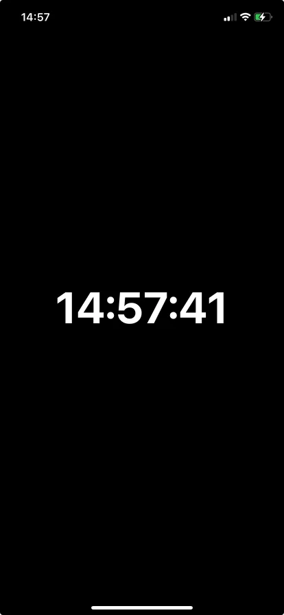 The screensaver as it appears before the display blanks — a clock on black, not your dashboard burning in overnight.